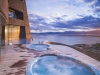 Outdoor swimming pool and jacuzzi at sunset
